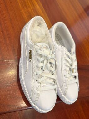 Puma Women’s White Leather Sneakers with Gold Puma Accent . Never worn .